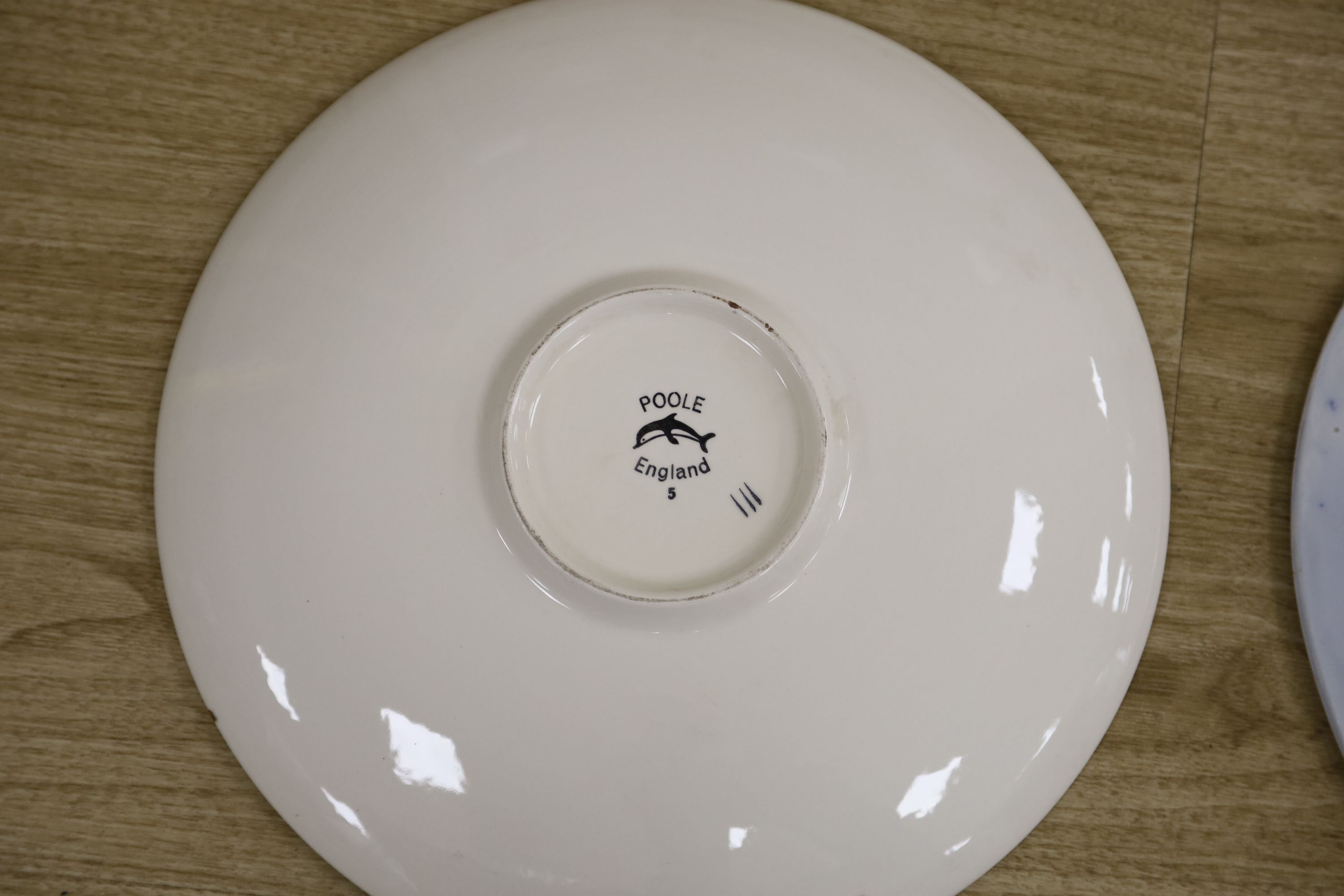 A Poole pottery charger and a blue and white oval Ashworth dish, length 55cm